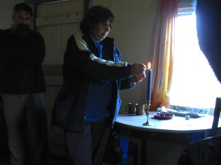Image of Gloria Andrews lighting symbolic fire
